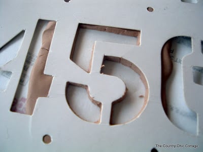 Number 5 cut out of clay.