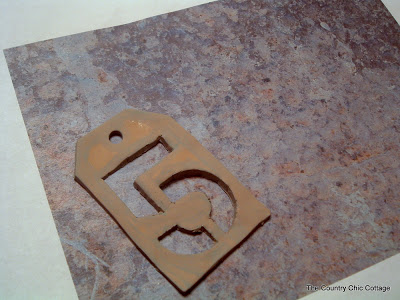 Painted DIY numbered tag with rusted paper.