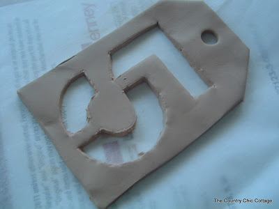 Use a straw to add the hole to the clay tag.
