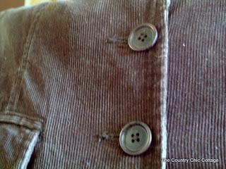 close up of buttons on corduroy pillow made from jacket