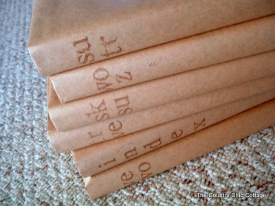 stack of brown paper bag covered books