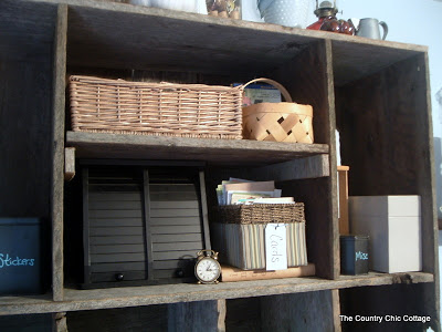 aged wood hutch with baskets and office supplies