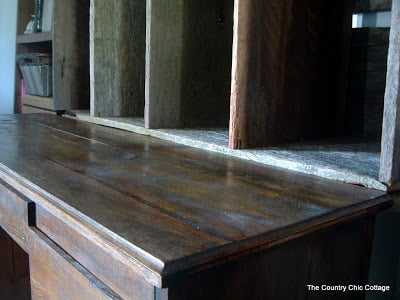 close up of barn wood hutch attached to wooden desk