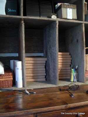 stacked books on wooden hutch