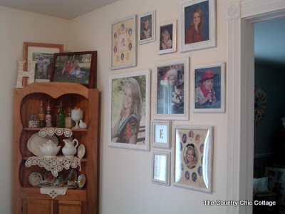 framed art gallery wall next to pine shelf