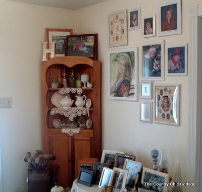 pine shelf with antique finds next to gallery wall