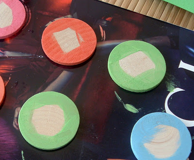 Paint the wooden circles bright colors