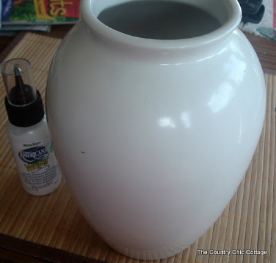white vase with americana paint bottle