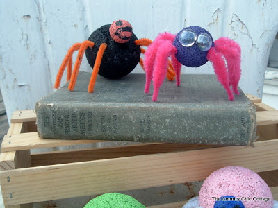 2 spider crafts sitting on a book