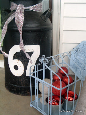 67 jug and cage with Christmas ornaments on front porch