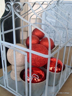 wire cage with red ornaments