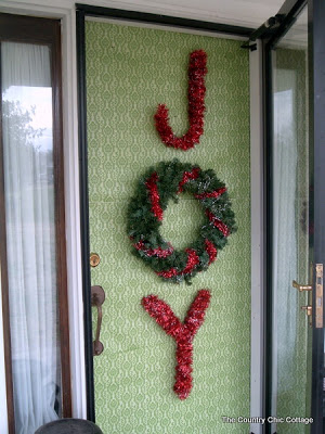 Joy wreath on green front door