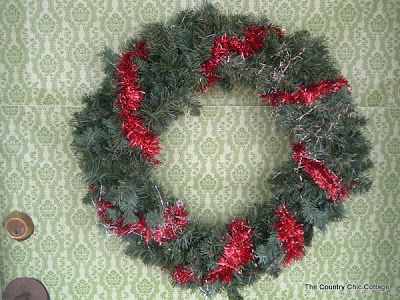 faux greenery wreath with red ribbon