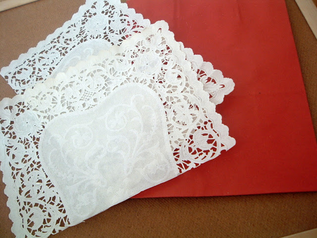 white paper doilies on a red gift bag