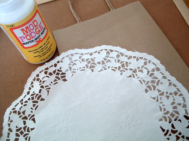 round paper doily on top of brown kraft bag with Mod Podge