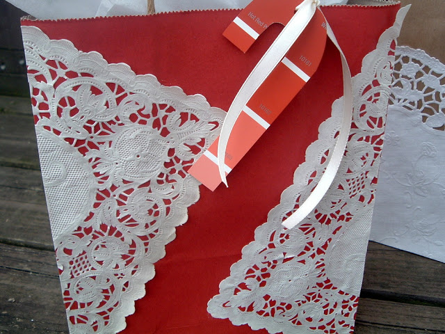red and white holiday gift bag with candy cane tag