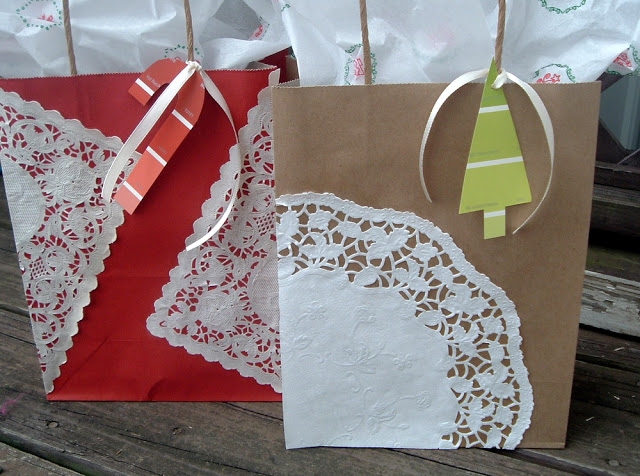 two embellished gift bags on wood