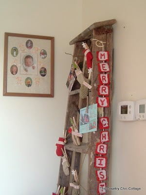 Glitter Christmas banner on rustic ladder with Christmas cards.