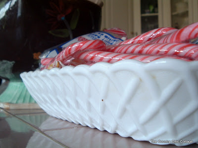 shallow white bowl filled with candy canes