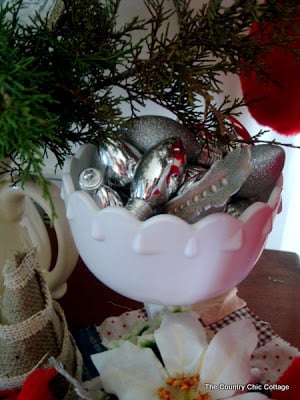 white pedestal vase with silver ornaments