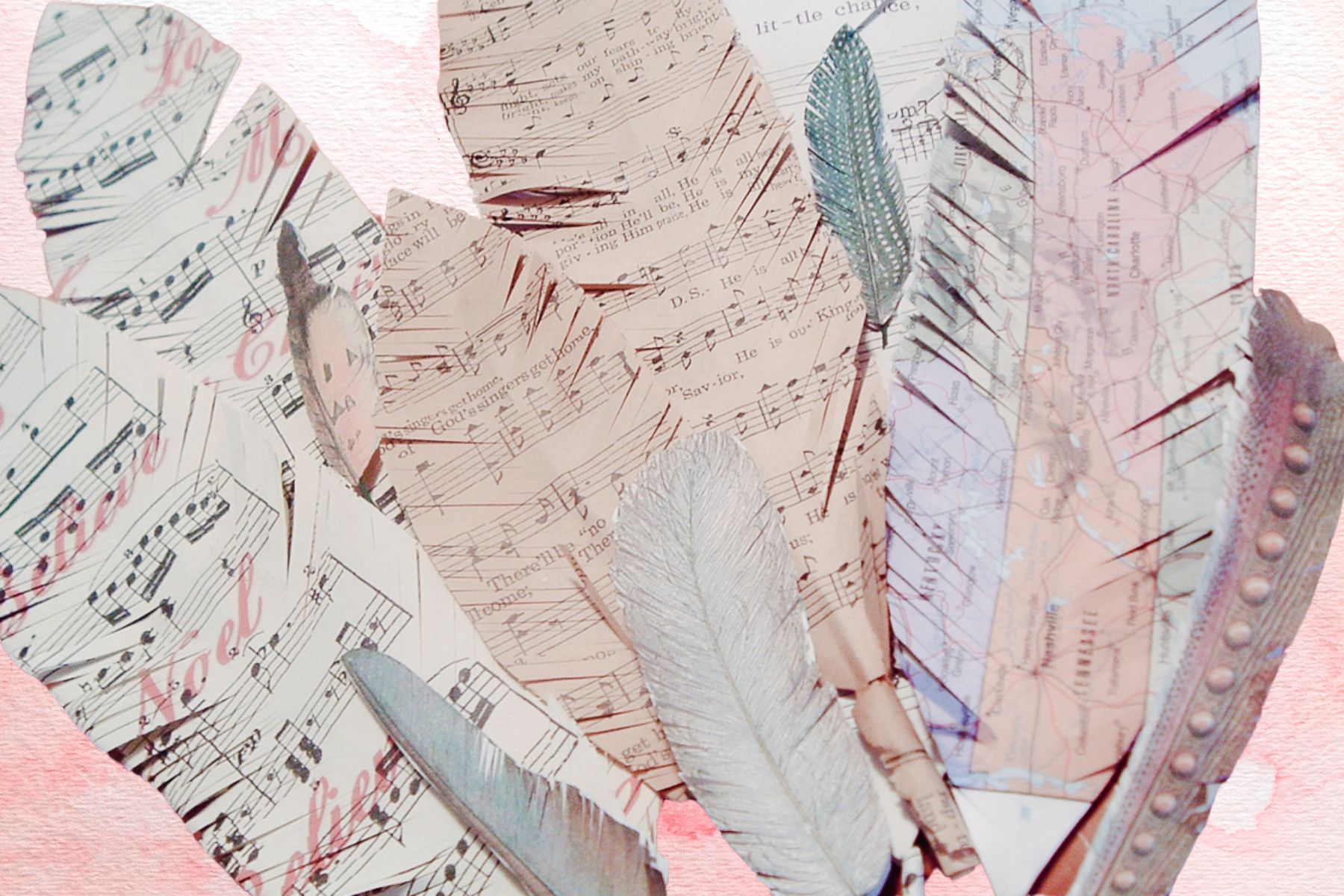 paper feathers on a pink background