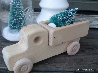 wooden toy truck carrying a Christmas tree