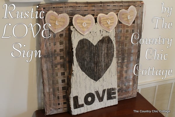 Wooden sign painted white with heart and word "love"