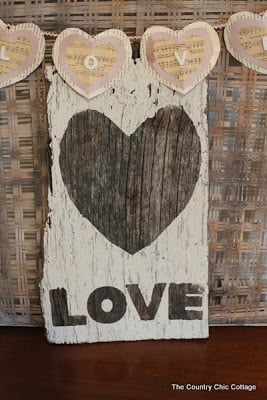 Wooden sign painted white with heart and word "love"