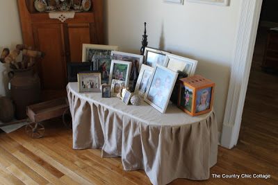 skirted table with picture frames on top