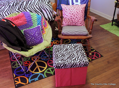 brightly colored pillows and a zebra covered crate 