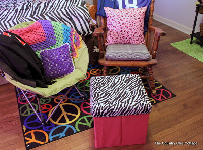 brightly colored pillows and a zebra covered crate