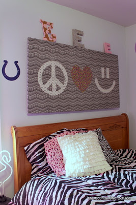 peace sign art hung above bed