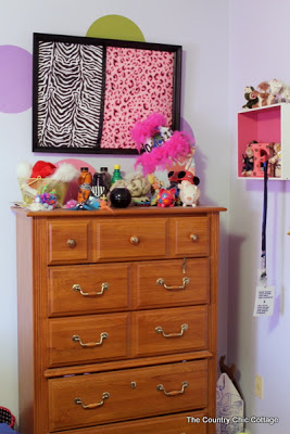 zebra fabric art hung above dresser