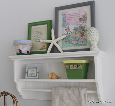 Styled bathroom shelf with books.