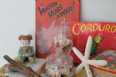 Close up of books on chest of drawers.