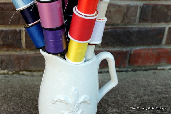 spools of thread organized in pitcher