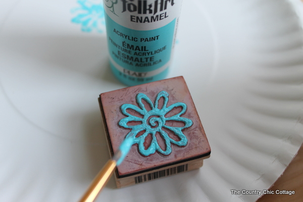 painting a flower stamp with turquoise paint