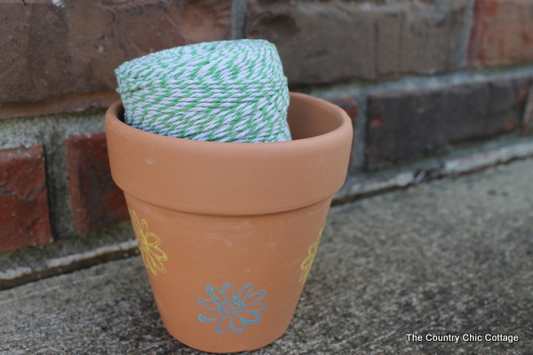 green twine inside of a terra cotta planter