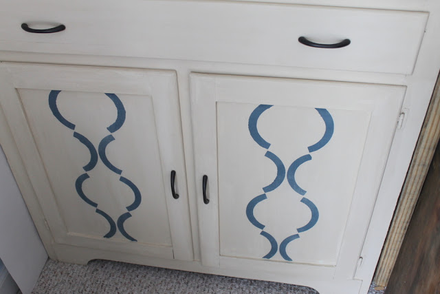 cream cabinet with blue accents