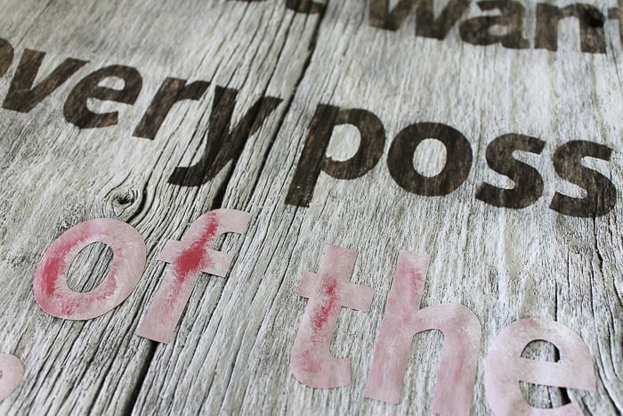 Removing vinyl masking after painting a quote on a barn wood sign