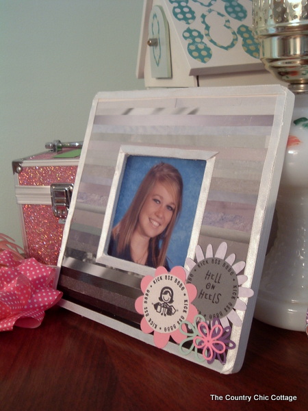 embellished picture frame on a wooden desk made from old magazines