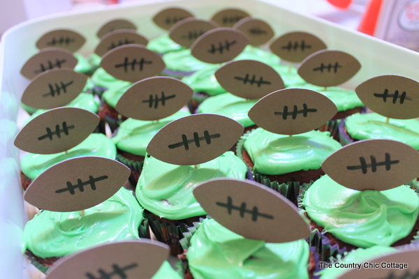 Assembling football cupcakes.