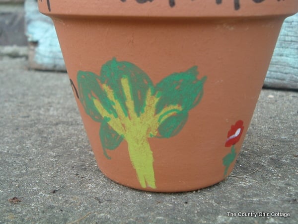 terra cotta flower pot with a painted tree