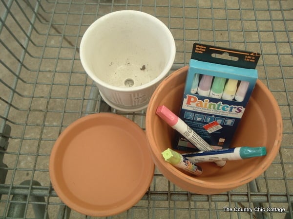 flower pots and paint marker supplies in a shopping cart