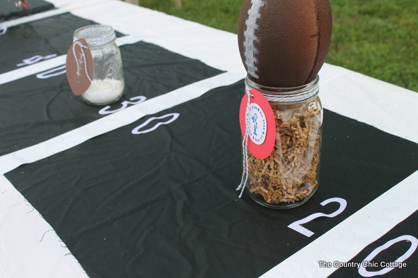 Mason jar football centerpiece with baker's twine and tag.