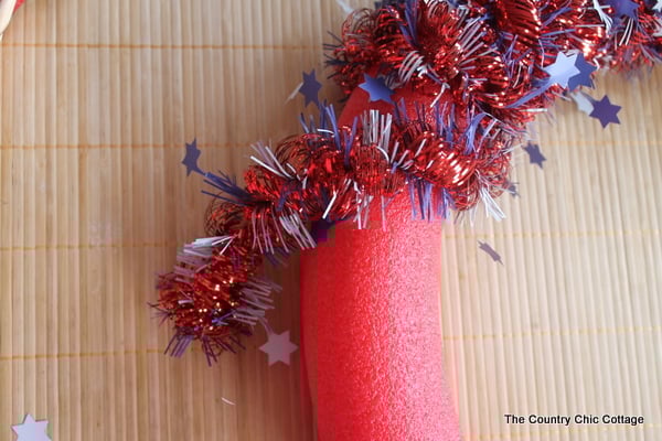 July 4th wreath decor wrapping garland around pool noodle