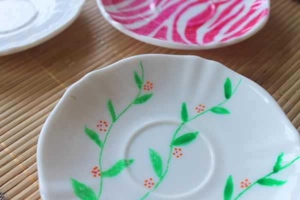 white plate with green vines and red flowers