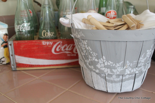 gray painted basket in front of vintage coke crate