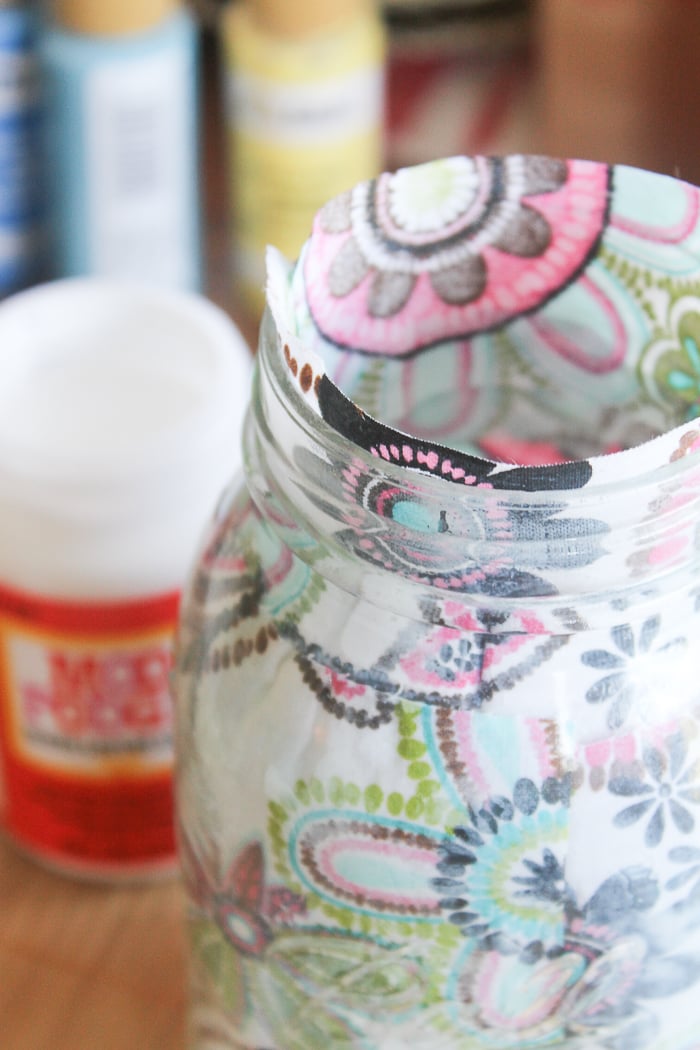 It's okay of the fabric comes up over the edge of the mason jar--you can trim that down once dry!