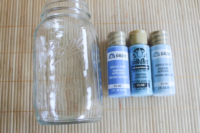 For this blue ombre mason jar, you need one large mason jar and 3 shades of acrylic blue paint